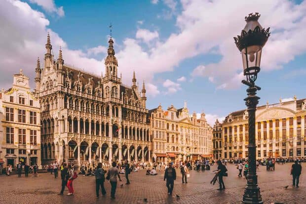 People walking around a historic square with ornate buildings in Brussels showcasing classic European architecture, HD Desktop Wallpaper