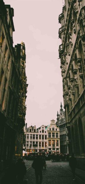 People walking on the cobblestone street among historic buildings in Brussels, 2K Mobile Wallpaper