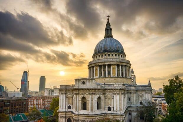 The cathedral dome stands tall against a cloudy sunset sky in the city, HD Desktop Wallpaper
