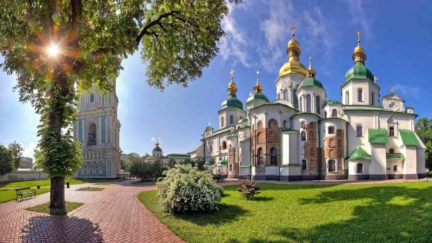 The image shows a historic cathedral with green domes under a bright blue sky in Ukraine, HD Desktop Wallpaper