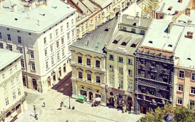 A historic street view in Ukraine with colorful buildings and pedestrians, HD Desktop Wallpaper