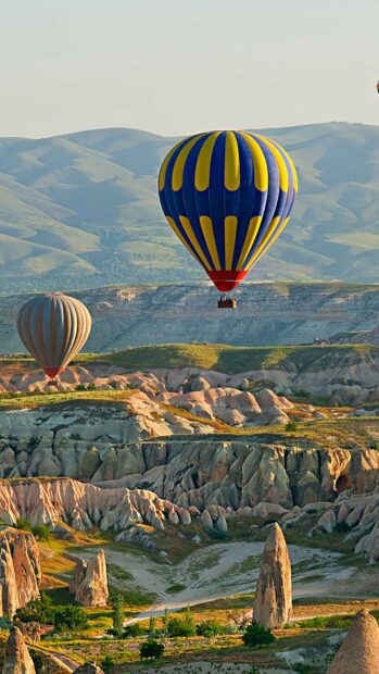 Cappadocia wallpapers show hot air balloons floating above rocky landscapes, HD Phone Wallpaper
