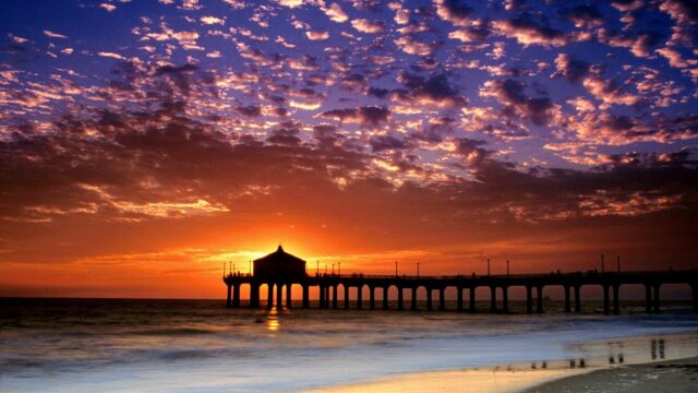 Huntington Beach Pier Sunset with Vibrant Sky and Ocean Waves Wallpaper