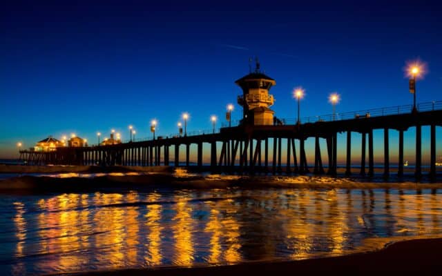 Huntington Beach Pier at Night with Beautiful Reflections on Water Wallpaper