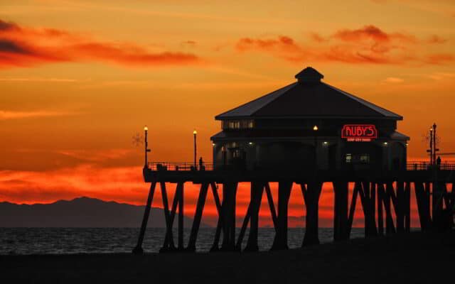 Huntington Beach Pier at Sunset with Ruby's Surf City Diner Neon Sign in Background