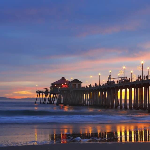 Huntington Beach Pier at Sunset with Vibrant Sky and Ocean Reflections Wallpaper