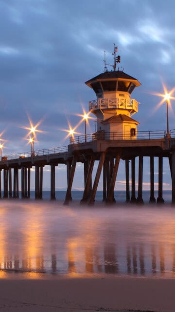 Huntington Beach Pier at Twilight with Calm Ocean and Soft Lights Wallpaper