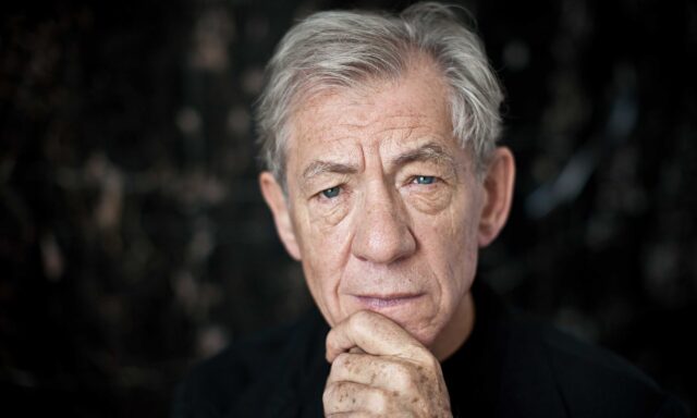 Ian McKellen Close Up Portrait Wallpaper With Thoughtful Expression And Dark Background