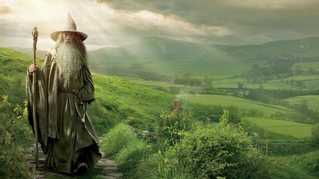 Ian McKellen As Gandalf In Scenic Green Landscape Wallpaper For Fans