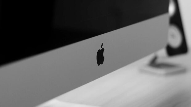 The Imac logo appears prominently on the aluminum surface of the computer device, 2K Desktop Wallpaper