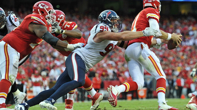 JJ Watt In Action On The Football Field Tackle Moment Wallpaper
