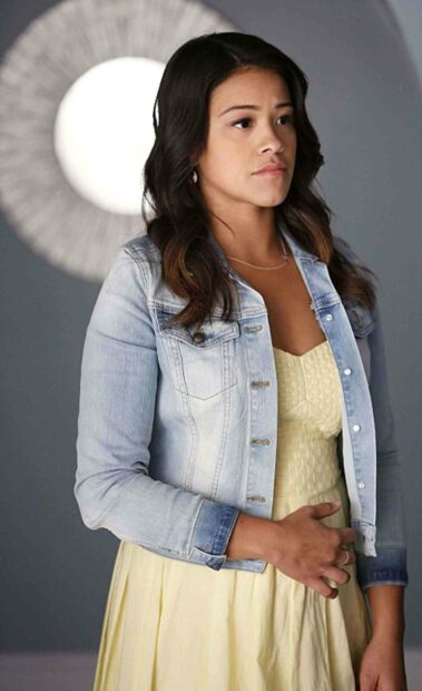 A thoughtful woman wearing a denim jacket and yellow dress in a Jane The Virgin scene, HD Phone Wallpaper
