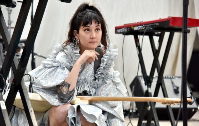 Japanese Breakfast Band Member In Stylish Performance Moment Wallpaper