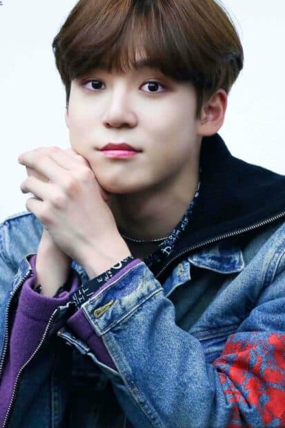 A close up portrait of Jeong Yun Ho with folded hands wearing a denim jacket, HD Mobile Wallpaper