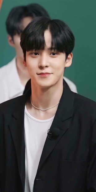 A close up portrait of Jeong Yun Ho wearing a black jacket and white shirt with a subtle smile, 2K Mobile Wallpaper