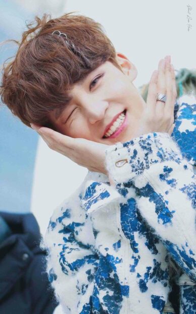 Jeong Yun Ho smiles warmly while posing with hands near his face in a blue and white patterned jacket, HD Phone Wallpaper