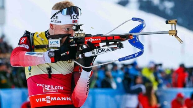 Johannes Thingnes aiming with a biathlon rifle during a competition event, 2K Desktop Wallpaper