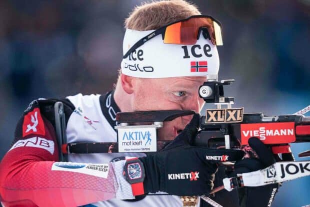 Johannes Thingnes is focused while aiming with his biathlon rifle during a competition, HD Desktop Wallpaper