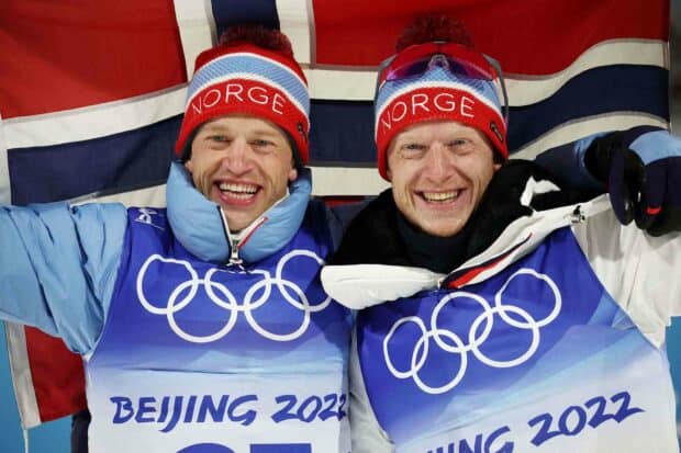 Two athletes wearing Norge hats celebrate their win at the Beijing 2022 Olympics with smiles and a flag, HD Desktop Wallpaper