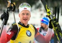 Johannes Thingnes is holding his skis and smiling after a competition, 2K Desktop Wallpaper