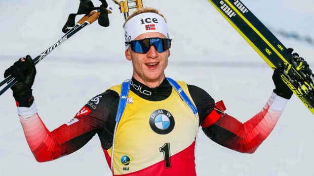 Johannes Thingnes is celebrating with his ski poles raised after a race, 2K Desktop Wallpaper