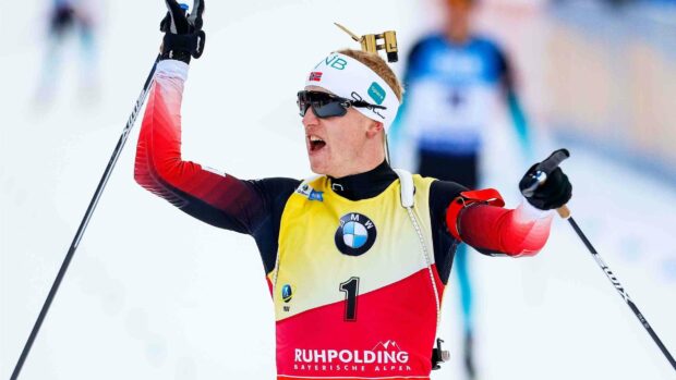 Johannes Thingnes celebrating his biathlon race victory with arms raised, 2K Desktop Wallpaper