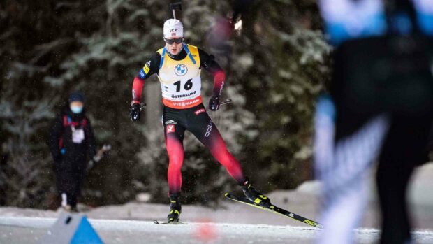 Johannes Thingnes Wallpapers shows a biathlete skiing in a snowy forest, 2K Desktop Wallpaper