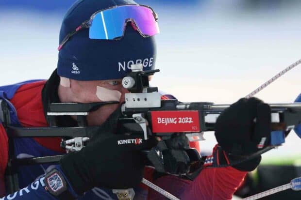 A biathlete intensely aiming during a competition, HD Desktop Wallpaper