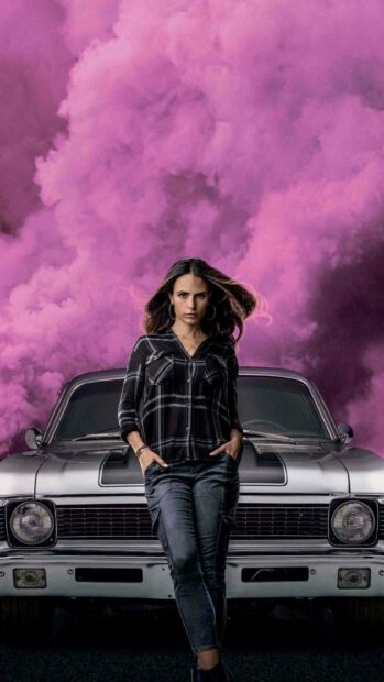Jordana Brewster stands confidently in front of a classic car with purple smoke in the background, HD Mobile Wallpaper