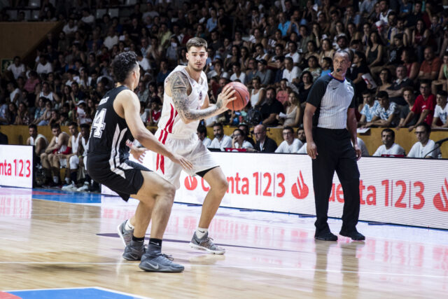 Juancho Hernangomez Basketball Action Wallpaper With Defensive Opponent And Referee On Court