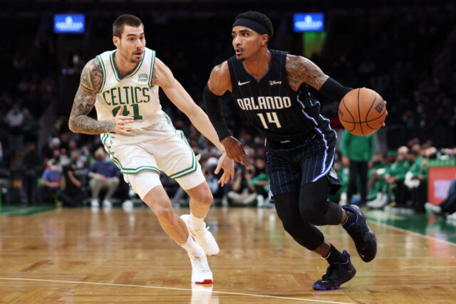 Juancho Hernangomez In Action Dribbling Against Celtics Defender During NBA Game