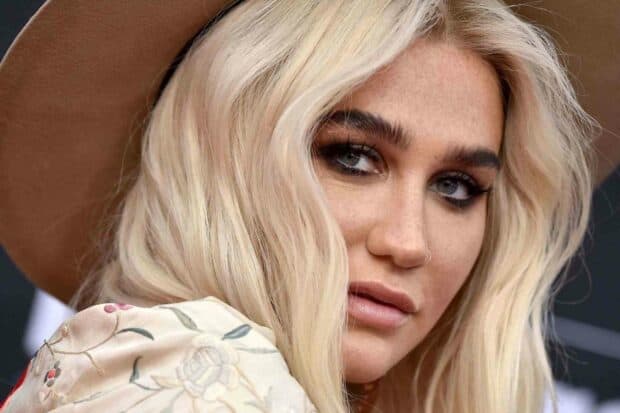 Kesha Wallpapers shows a close up portrait of a blonde woman with striking blue eyes and a brown hat, HD Phone Wallpaper