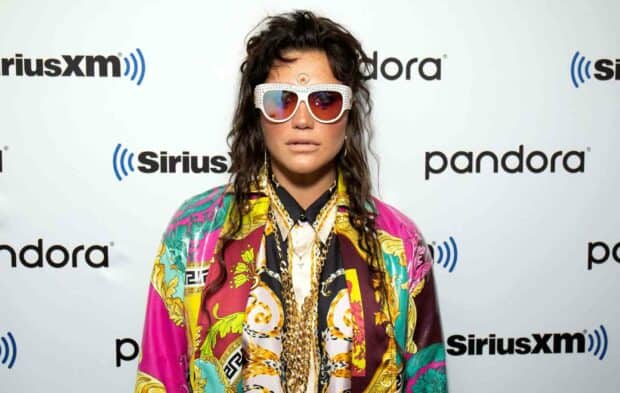 Kesha wears vibrant patterned clothing with sunglasses at a music event, HD Desktop Wallpaper