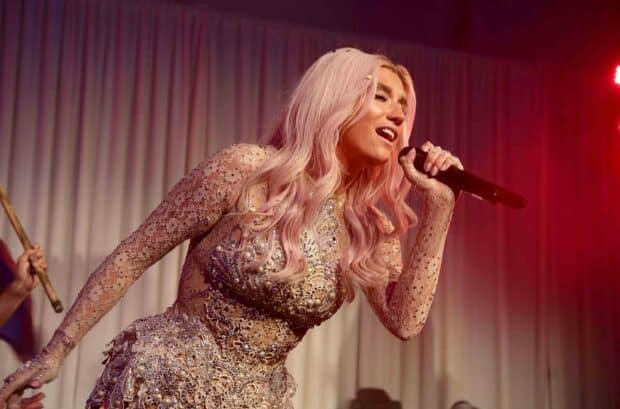 Kesha is passionately performing on stage wearing an embellished outfit, 2K Desktop Wallpaper