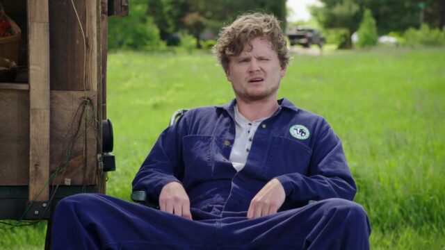 Letterkenny TV Series Wallpaper Featuring Character In Blue Coveralls Outdoors