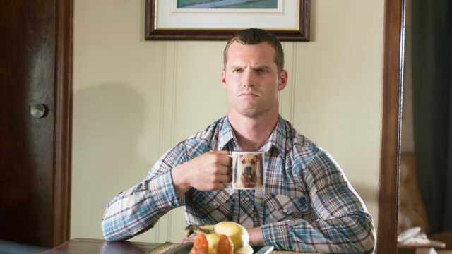 Letterkenny TV Series Wallpaper With Character Holding Dog Print Mug In Plaid Shirt