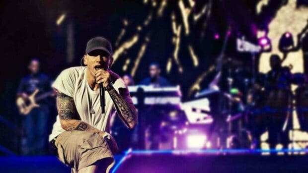 A singer with tattoos performs passionately on stage during a concert, HD Desktop Wallpaper