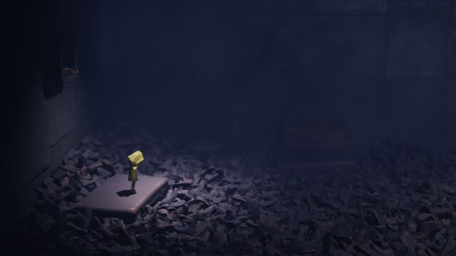 Lonely character in yellow raincoat standing on platform surrounded by shoes puzzle game wallpaper