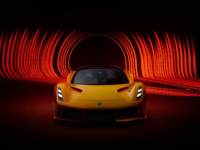 Lotus Evija Wallpaper Front View Of Yellow Electric Hypercar With Red Light Trails Background