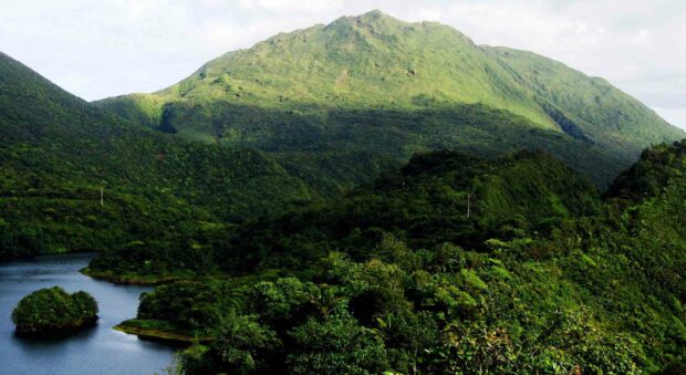A lush green mountain covers the landscape under a cloudy sky in Dominica Wallpapers, HD Desktop Wallpaper
