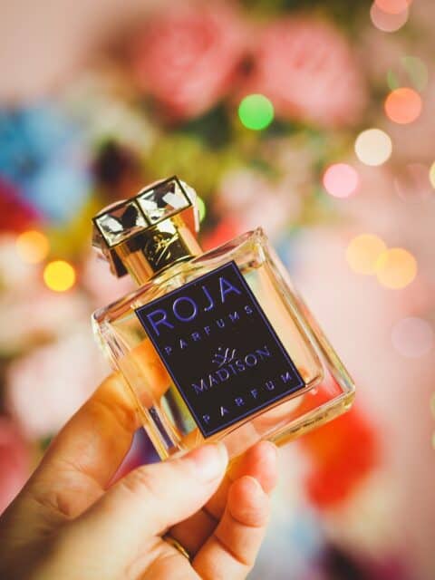 Luxurious Roja Parfums Bottle With Floral Background