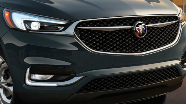 The image shows a close up of the front grille and headlights of a Buick Enclave, highlighting its design features, 4K Desktop Wallpaper