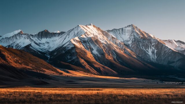 Mac OS X Background HD, Majestic Snow Capped Mountain Peaks Towering Over A Serene Valley, Illuminated By Golden Sunlight During The Early Morning Hours
