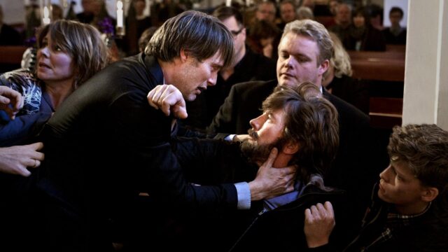Mads Mikkelsen Dramatic Scene In Tense Movie Moment Wallpaper