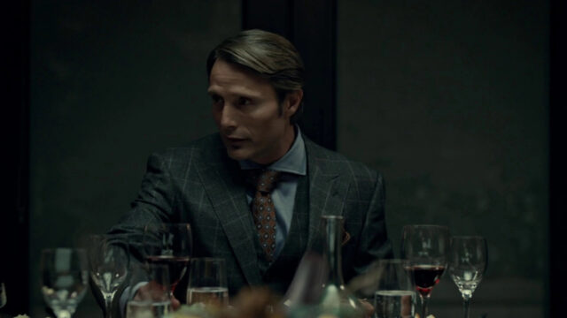 Mads Mikkelsen In Elegant Suit At Dinner Table Wallpaper