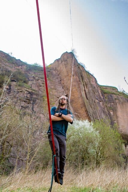 Man Balancing on Red Slackline with Rocky Cliff Background Slacklining Wallpapers