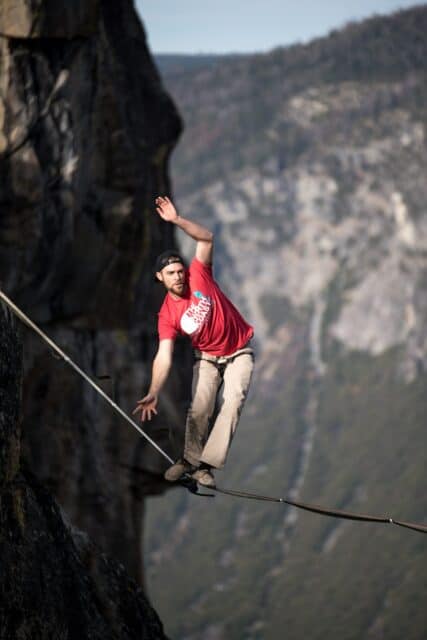 Man Balancing on Slackline Between Cliffs in Mountain Landscape Slacklining Wallpapers