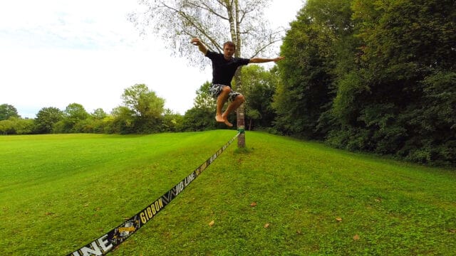 Man Jumping on Slackline in Green Park Slacklining Wallpapers