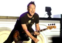 Mark Hoppus enthusiastically plays guitar during a live performance, 2K Desktop Wallpaper