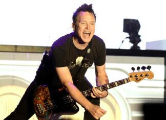 Mark Hoppus enthusiastically plays guitar during a live performance, 2K Desktop Wallpaper